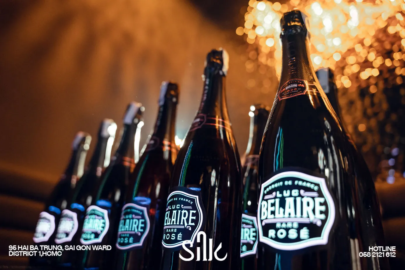 Row of Luc Belaire Rare Rosé bottles with sparkler celebration at Silk Lounge